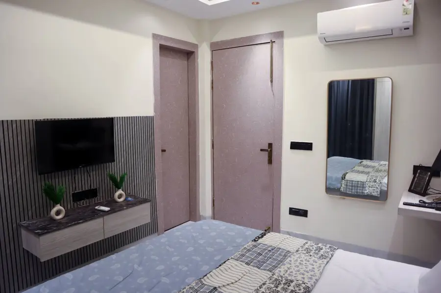 Bedroom with television and wardrobe